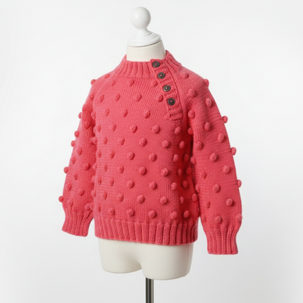 Pink textured sweater on a mannequin against a white background