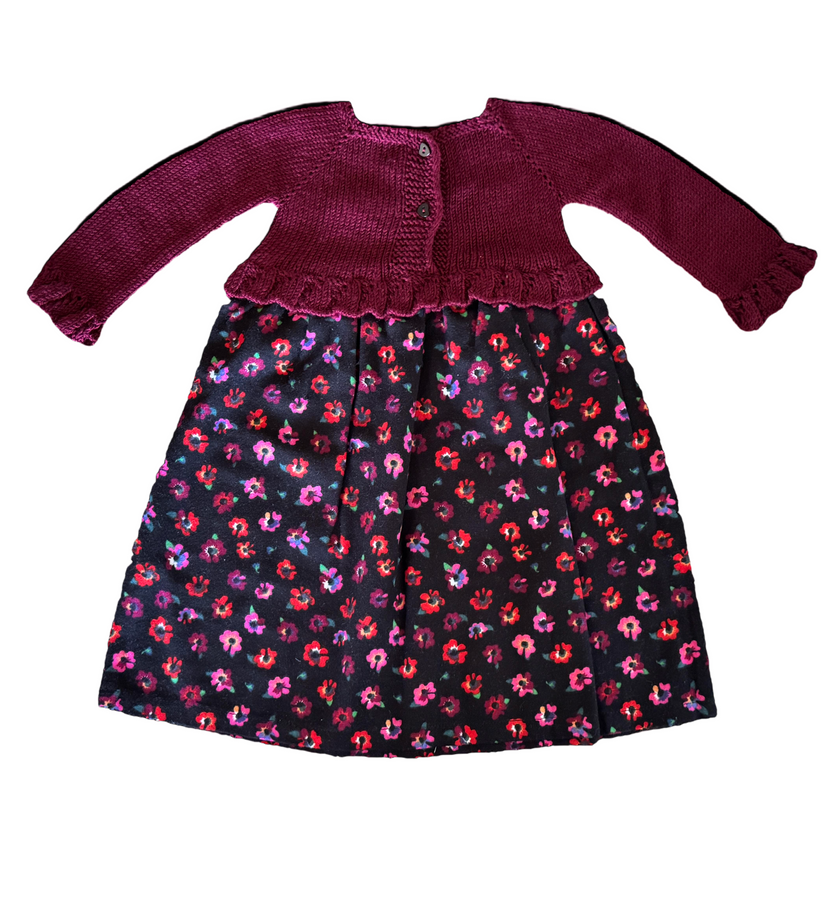 Burgundy knitted outfit with a colorful patterned blanket on a white background

