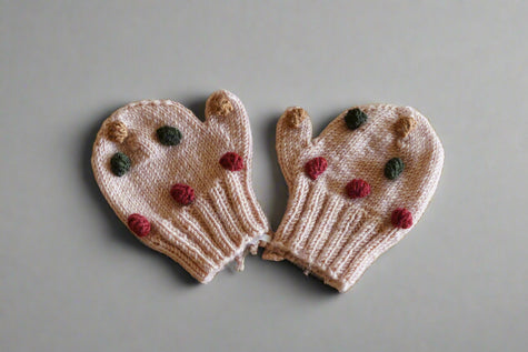 hand knitted beige mitten with colorful pops