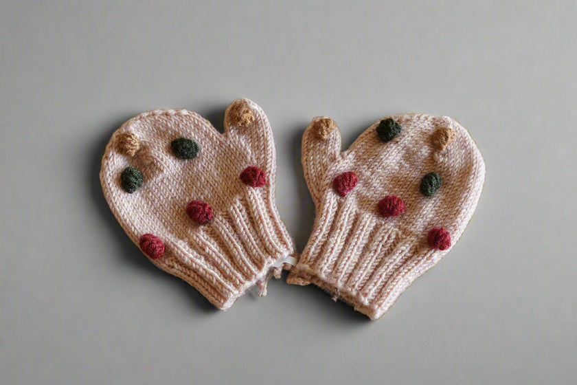 hand knitted beige mitten with colorful pops