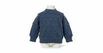 Blue knitted sweater with polka dots on a mannequin against a white background

