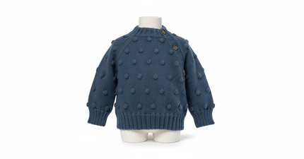 Blue knitted sweater with polka dots on a mannequin against a white background

