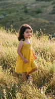 Girl wearing the mustard crochet sundress outdoors
