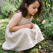 Child in the natural crochet dress in nature