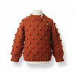 rust knitted sweater with textured design on a white background

