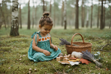 Young girl wearing the teal floral sundress in a meadow